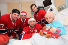 Kayla smiles with players from the Montreal Canadiens. 