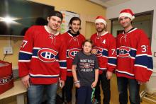 Gregory smiles with Alex Galchenyuk, Phillip Danault, Andre Markov and Al Montoya. 