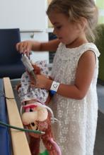 Tazia makes sure to hook her teddy bear up to an oxygen saturation machine to monitor his condition throughout the surgery. 